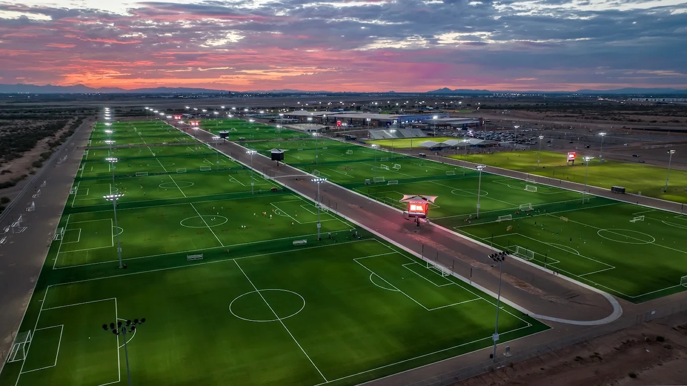 Existing AAG campus · playing fields at sunset